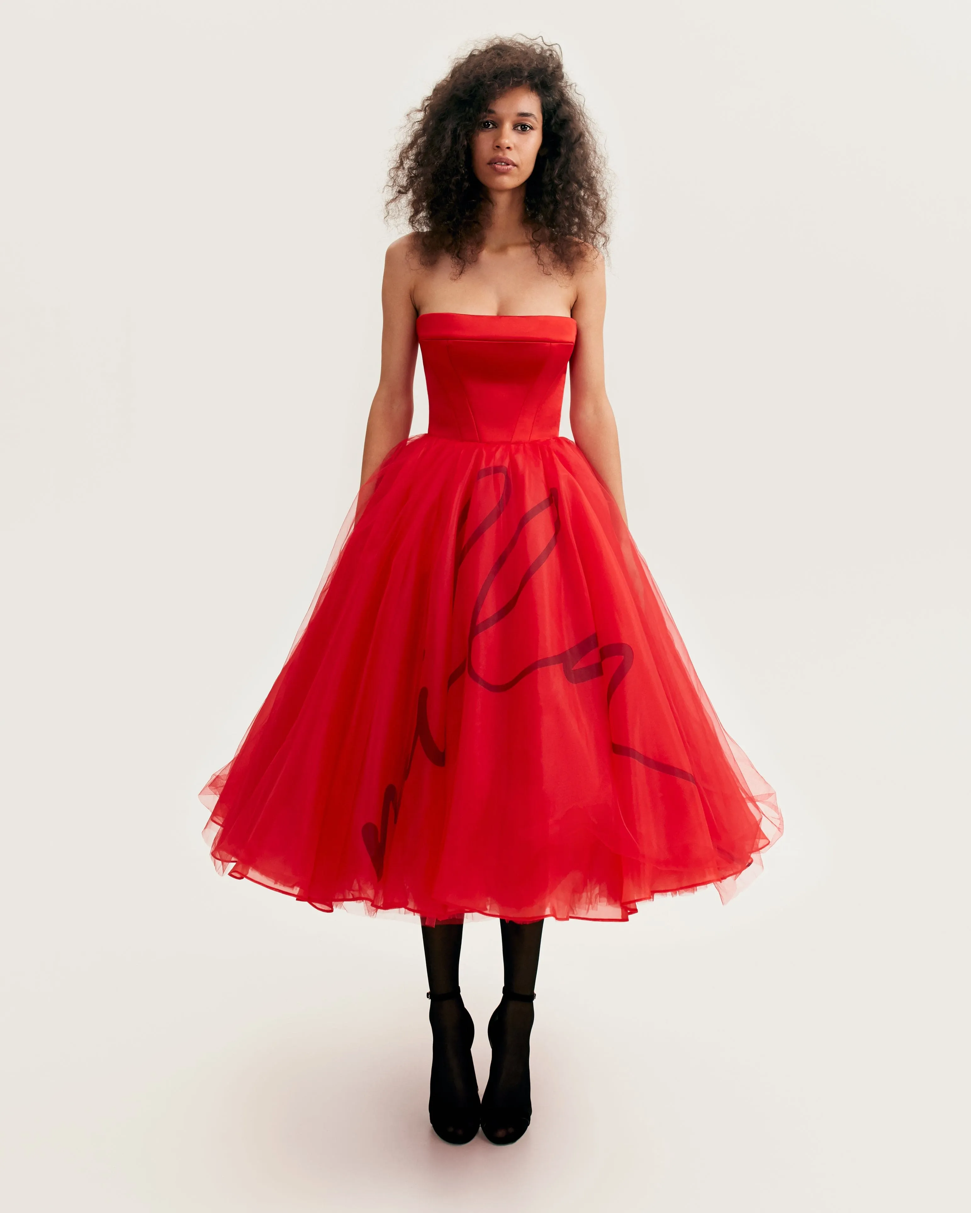 Dramatic red organza dress adorned with Milla's signature and black gloves, Xo Xo